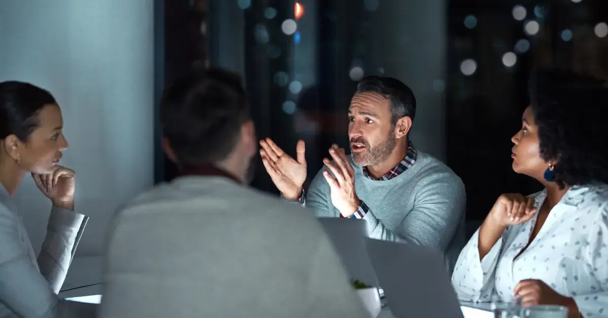 man chatting to colleagues